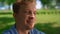 Portrait of calm man on meadow close up. Cheerful father sitting on grass.