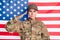 Portrait of calm serious lady arm head saluting greetings look focused camera isolated on usa national flag