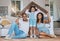 Portrait, cardboard roof and family in the lounge, home insurance and care with protection, smile and safety. Face