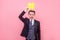 Portrait of carefree funny man holding large yellow hashtag symbol over head. studio shot isolated, pink background