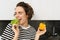 Portrait of carefree vegetarian girl, eating vegies, bite lettuce leaf with happy smiling face, having healthy snack