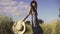 Portrait of a carefree young beautiful girl in a field with a straw hat. Young woman playfully smiling at the camera