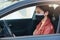 Portrait of careful experienced driver looking aside, driving car, wearing antibacterial mask for covid19 protection, sticking to