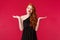 Portrait of careless indecisive young caucasian female redhead in elegant black dress, shrugging and smirk uncertain