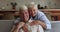 Portrait caring aged wife hug from behind laughing elderly husband
