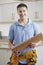 Portrait Of Carpenter Installing Fitted Kitchen