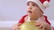 portrait caucasian baby kid toddler Santa costume red hat playing golden balloon