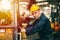 Portrait of Caucasian factory worker handsome smart with safety clothes and yellow helmet