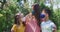 Portrait of caucasian family wearing face masks and standing together in the garden