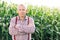 Portrait Caucasian Farmer Man in Plaid Shirt Looking in Corn Field. Farmland Sunset Landscape Agriculture. Portrait