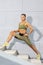 Portrait of Caucasian Female Athlet In Running Outfit Doing Legs Muscles Stretching Exercises Outdoor