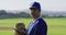 Portrait of caucasian of female baseball player, pitcher, holding ball in glove on field