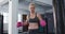 Portrait of Caucasian female boxer wearing boxing gloves at the gym