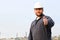 Portrait of caucasian foreman showing thumbs up standing in construction site background.