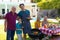 Portrait of caucasian grandfather, father and son barbecuing in the garden