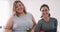 Portrait of caucasian lesbian couple keeping fit and holding bottles of water
