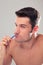 Portrait of a caucasian man brushing his teeth