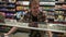 Portrait of caucasian man in plaid shirt looking on glass showcase, searching for products while doing shopping in