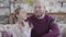 Portrait of caucasian man and teenage girl looking at each other, turning to camera and smiling. Young bearded father