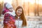 Portrait of Caucasian mother with child, a frosty evening, sunshine, sunset