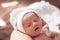 Portrait of caucasian newborn baby in white hat sleep