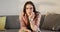 Portrait of caucasian non-binary transgender woman sitting on sofa, smiling