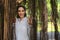 Portrait of caucasian pretty young woman posing under tree in park