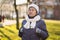 Portrait Caucasian senior woman with gray hair and deep wrinkles 90 years old posing in warm clothes, white knitted scarf and hat