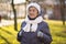 Portrait Caucasian senior woman with gray hair and deep wrinkles 90 years old posing in warm clothes, white knitted scarf and hat