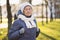 Portrait Caucasian senior woman with gray hair and deep wrinkles 90 years old posing in warm clothes, white knitted scarf and hat