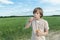 Portrait of Caucasian teenager boy with floating soap bubbles on dusty dirt farm field road