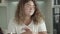 Portrait of Caucasian woman disinfecting hands with sanitizer before taking apple. Young chubby lady in eyeglasses