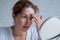 Portrait of a Caucasian woman with vitiligo disease uses sunscreen. A girl with a white pigment spot on her forehead