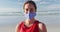 Portrait of caucasian woman wearing face mask at the beach