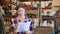 Portrait of caucasian woman working in warehouse, checking documentation.