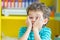 Portrait of Caucasious boy play a fun face in classroom at kindergarten preschool,kid education,