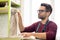 Portrait of Ceramist Dressed in an Apron Working on Clay Sculpture in Bright Ceramic Workshop.