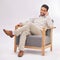 Portrait, chair and a man therapist sitting in a studio on a gray background ready to listen during counselling. Therapy