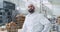 Portrait of charismatic baker man with beard smiling pretty in front of the camera in a commercial kitchen bakery