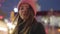 Portrait of charming caucasian woman in pink hat looking at camera and smiling. Beautiful young girl spending evening on