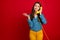 Portrait of charming cheerful cheery girl using receiver calling friend isolated over bright red color background