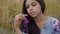 Portrait charming confident carefree African American girl enjoying sitting on the field looking at camera and up