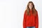 Portrait of charming energized and optimistic sportswoman with natural beautiful hair in stylish red oversized warm