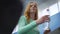 Portrait of charming fit slim sportswoman with water bottle running on treadmill in gym. Redhead Caucasian young woman