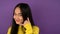 Portrait of charming flirting asian woman. Isolated on purple background. 4K