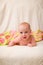 Portrait of charming four month caucasian baby on knitted plaid in selective focus