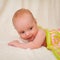 Portrait of charming four month caucasian baby on knitted plaid in selective focus