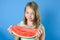 Portrait of charming girl with a big piece of ripe juicy watermelon.