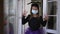 Portrait of charming girl in Halloween costume and coronavirus face mask gesturing looking at camera scaring. Positive