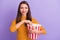 Portrait of charming lovely cute sweet girl hold pop corn striped box eat watching interesting film wear casual style